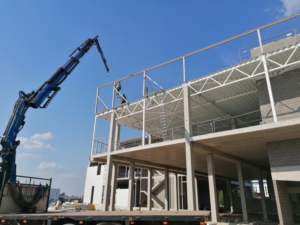 Steel truss assembly in workshop
